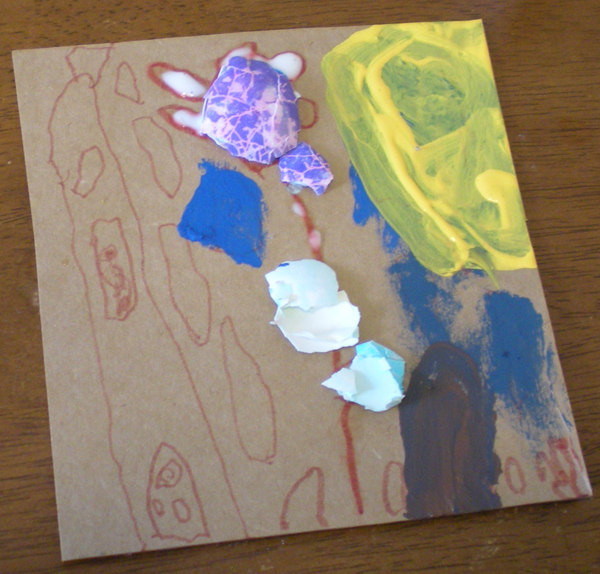 Eggshell mosaic embellished with yellow and blue paint, a tower and clouds